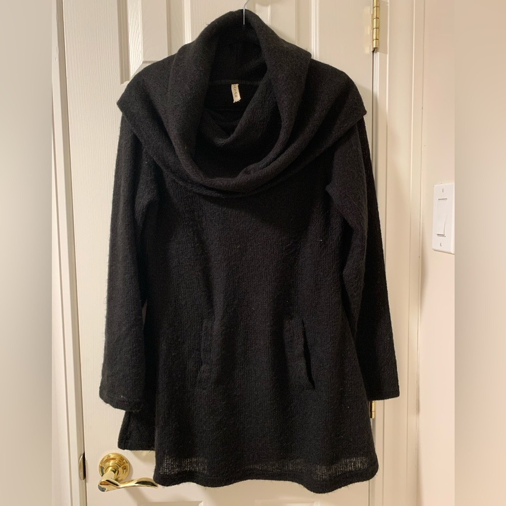 Knit sweater dress/tunic with front pocket detail.